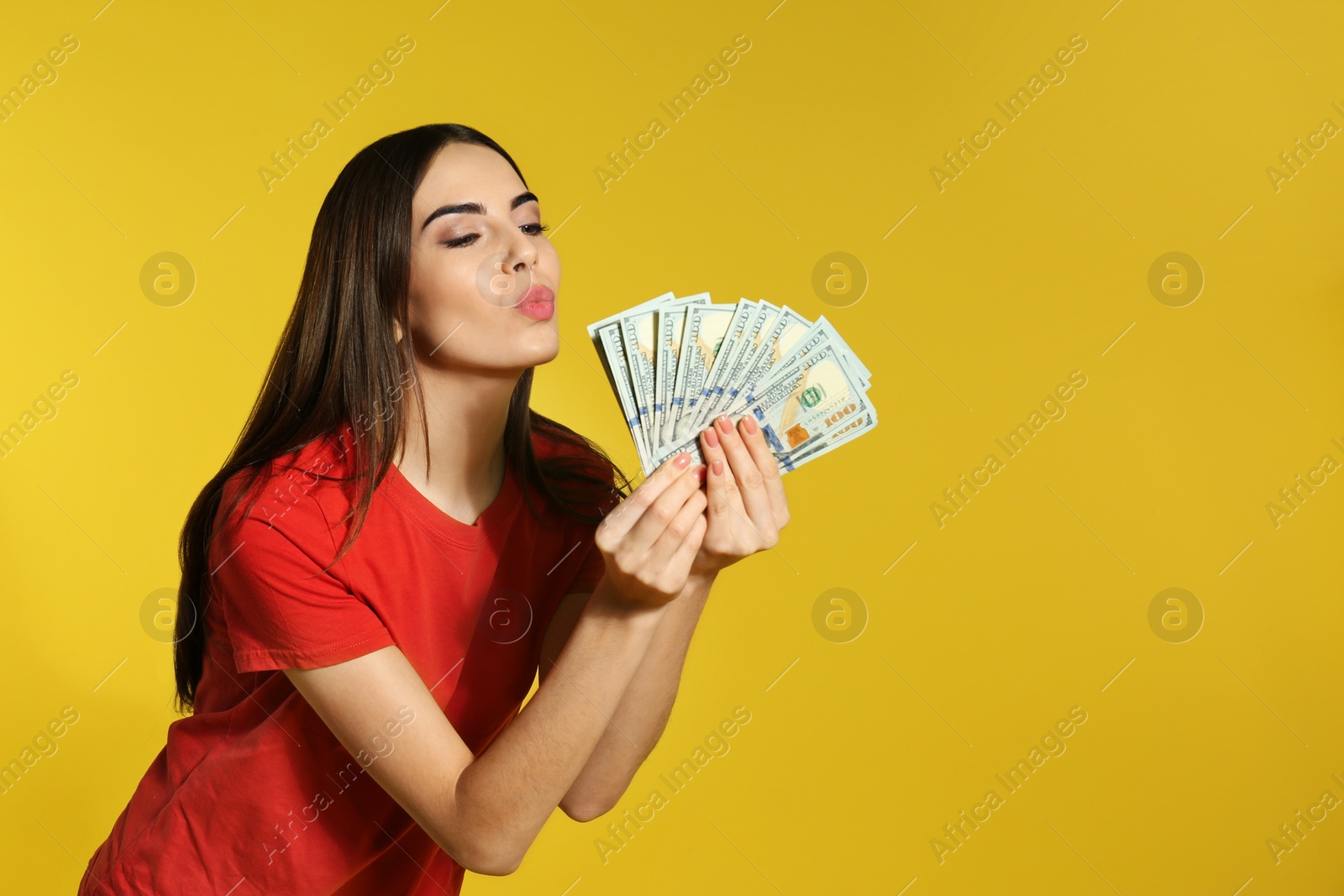 Photo of Young woman with money on color background. Space for text