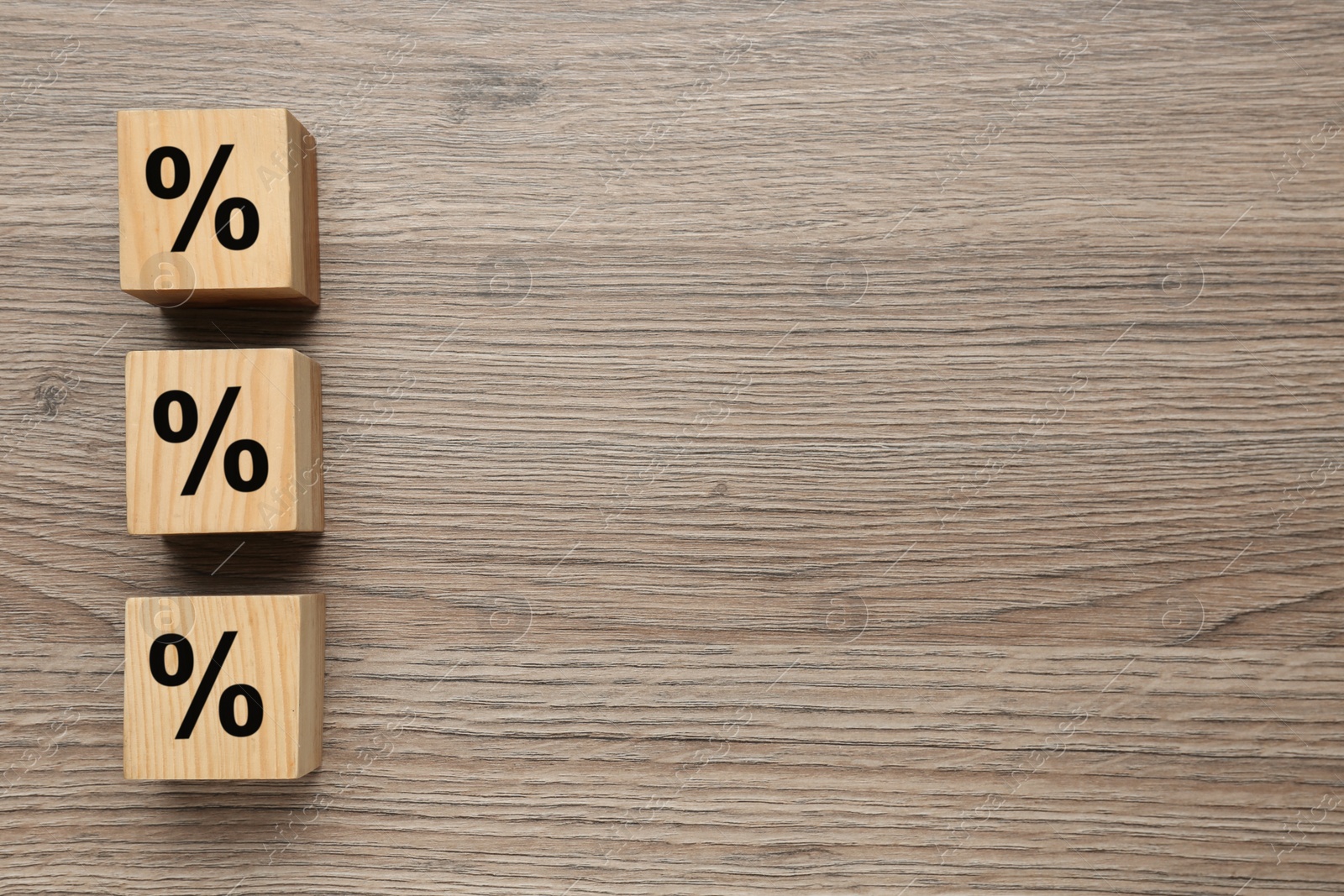 Photo of Wooden cubes with percent signs on table, flat lay. Space for text