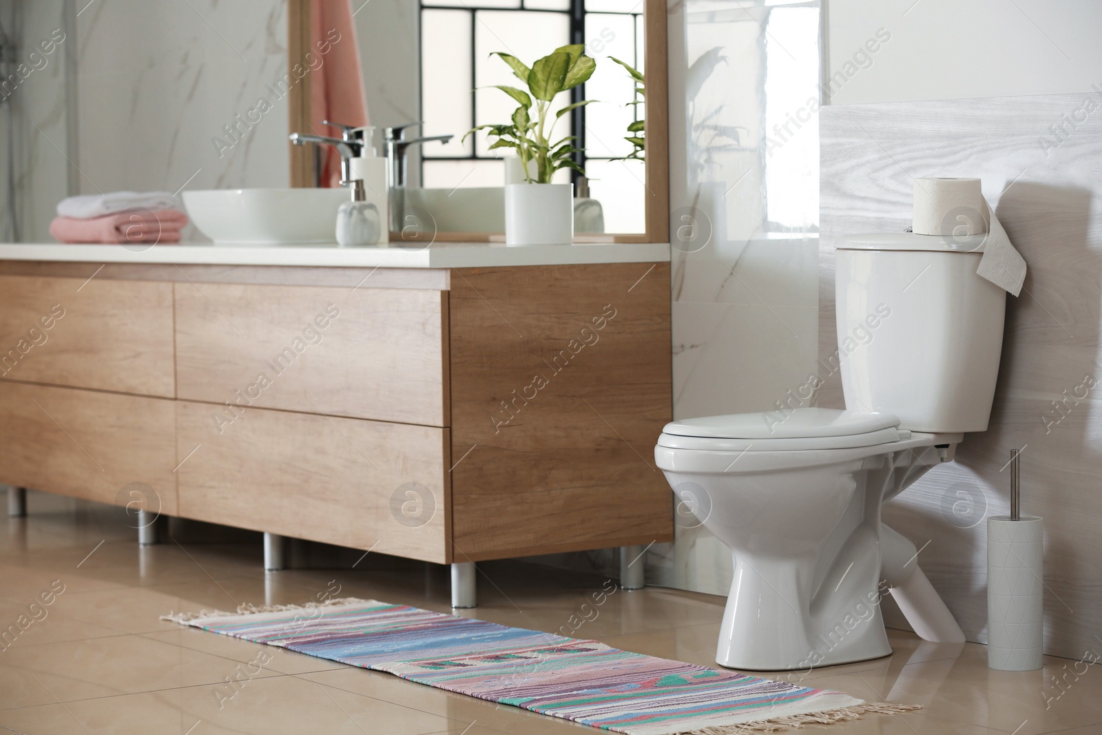 Photo of Interior of modern bathroom with toilet bowl