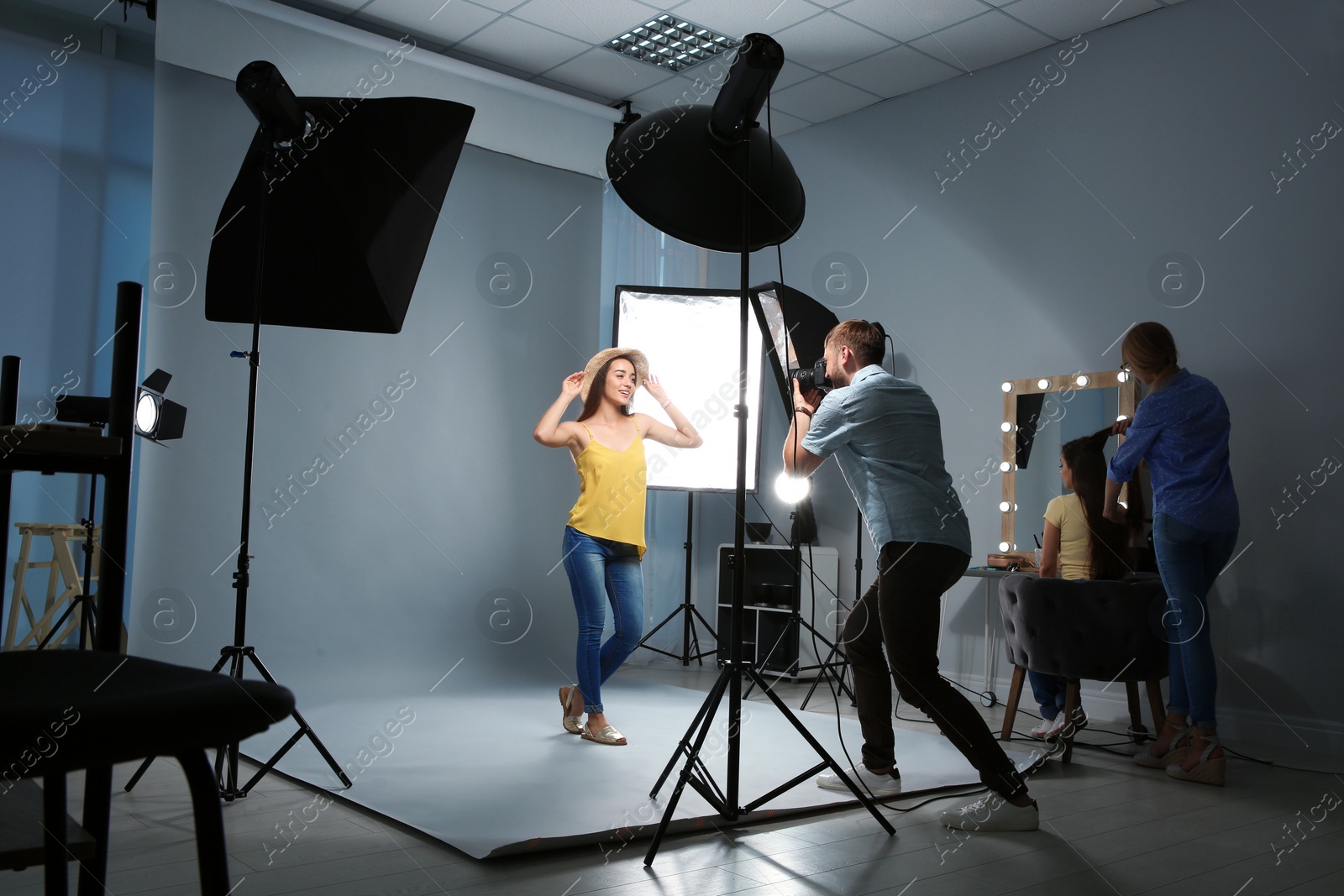 Photo of Beautiful model posing for professional photographer in studio