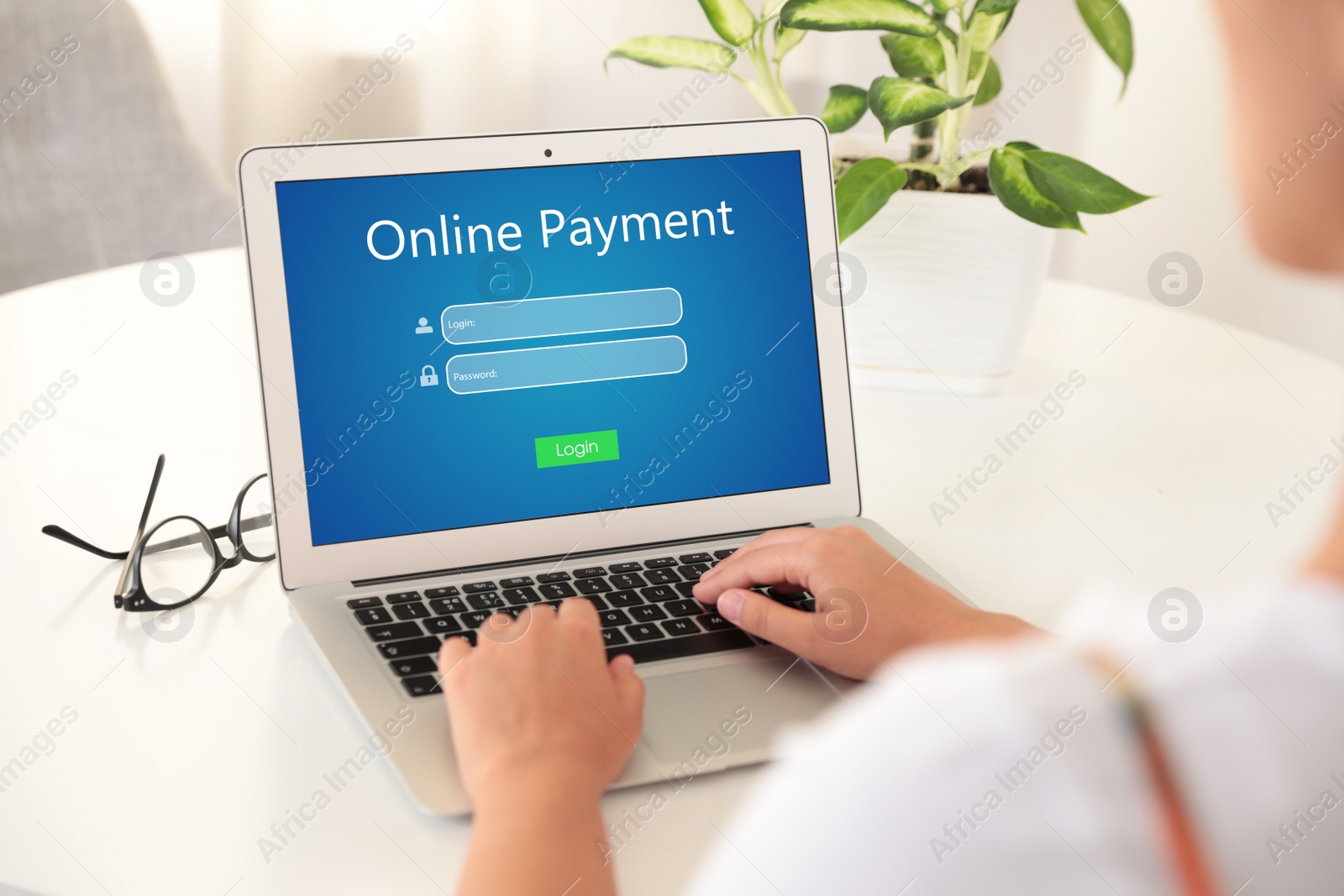 Image of Woman using laptop for online payment at table, closeup