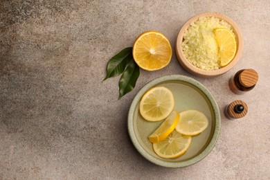 Photo of Flat lay composition with essential oil and lemons on grey textured table, space for text. Aromatherapy treatment