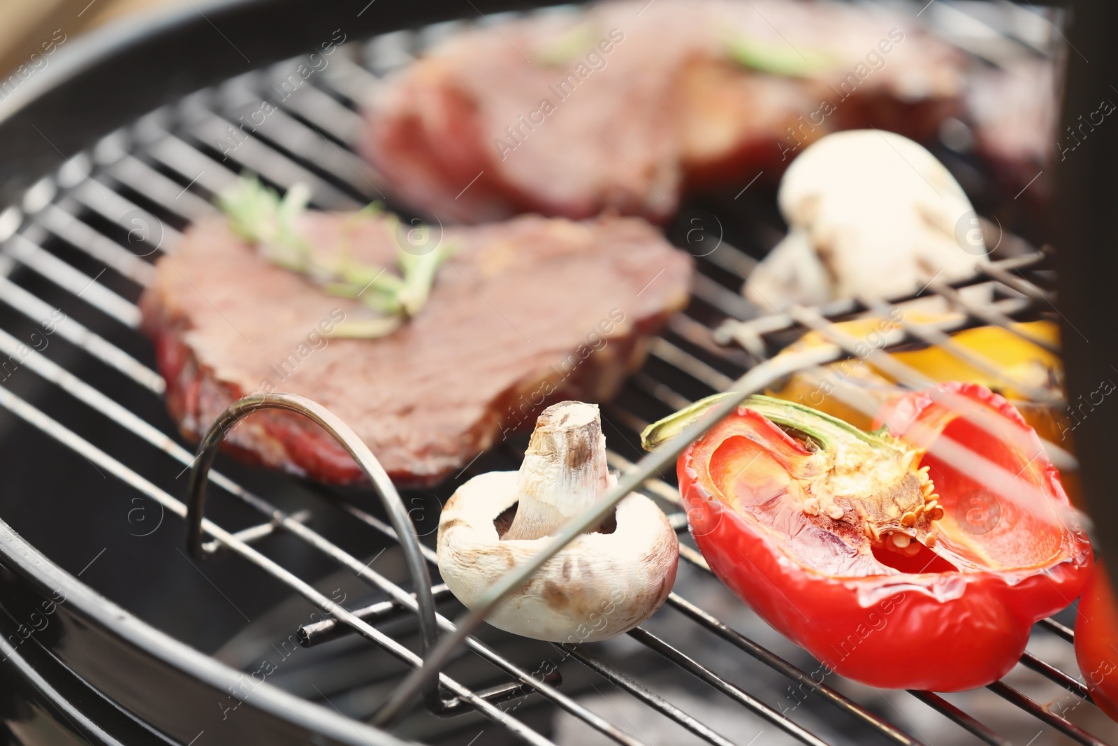 Photo of Modern grill with meat and vegetables outdoors, closeup