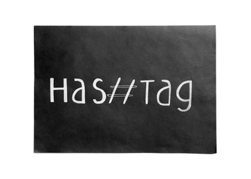 Photo of Black paper with word Hashtag and symbol on white background, top view