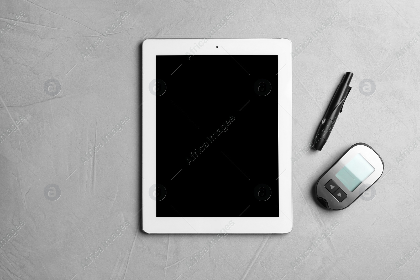 Photo of Tablet with space for text and medical devices on gray background, flat lay