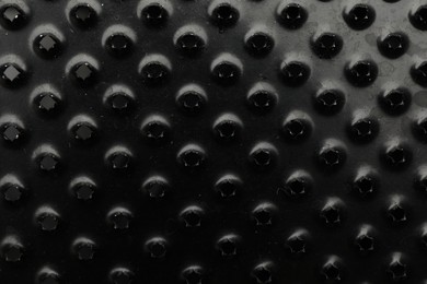 Photo of Modern black grater as background, top view