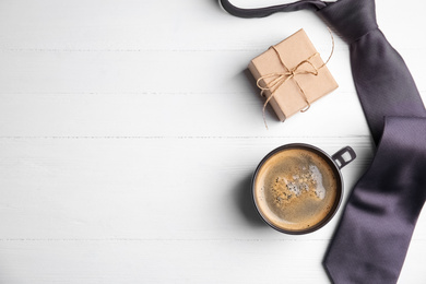 Photo of Tie, coffee and gift box on white wooden table, flat lay with space for text. Happy Father's Day