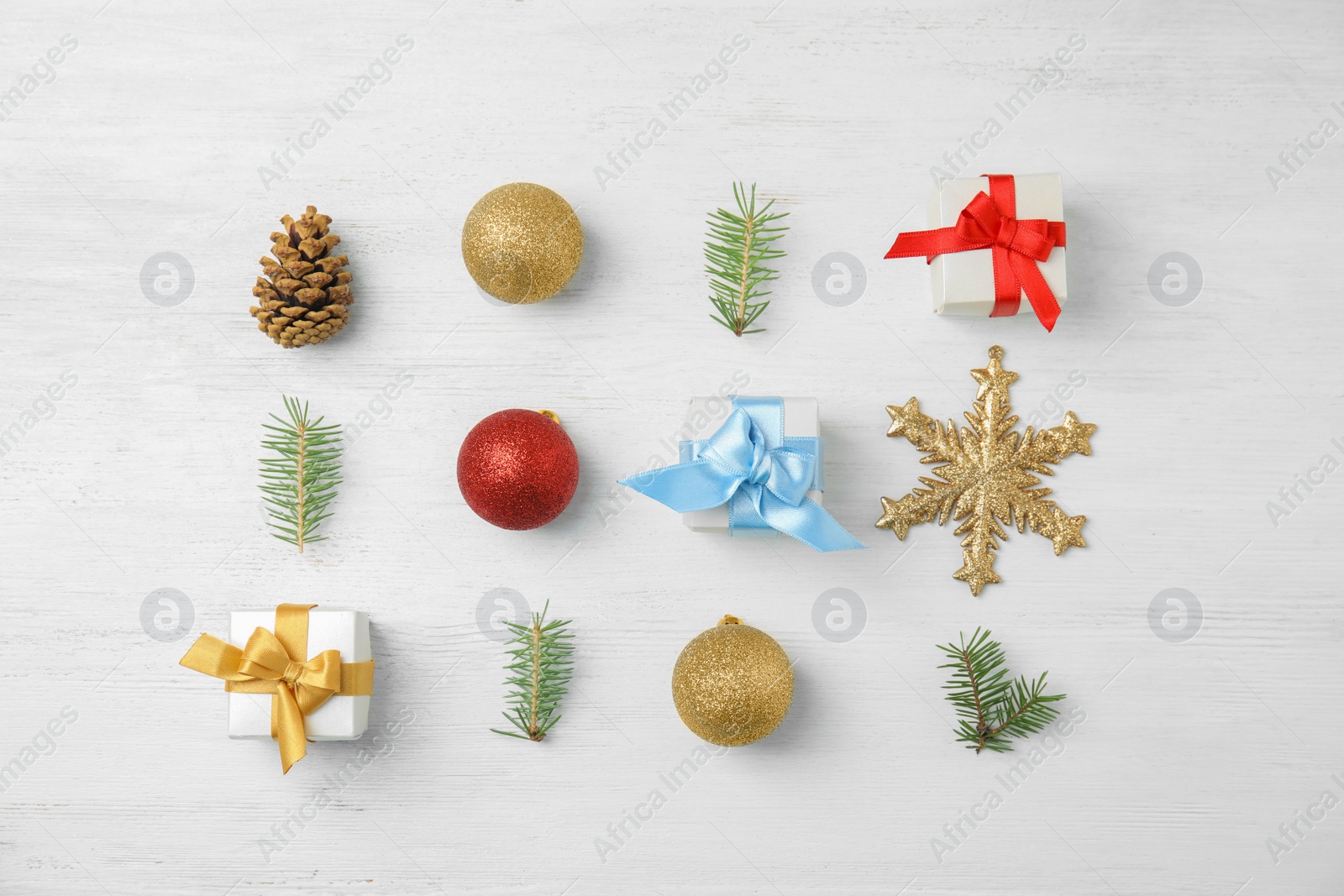 Photo of Flat lay Christmas composition with gift boxes and festive decor on wooden background