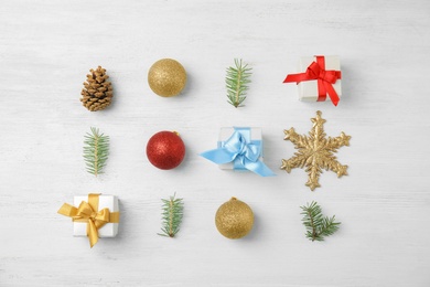 Photo of Flat lay Christmas composition with gift boxes and festive decor on wooden background