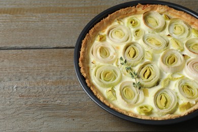 Tasty leek pie on wooden table. Space for text