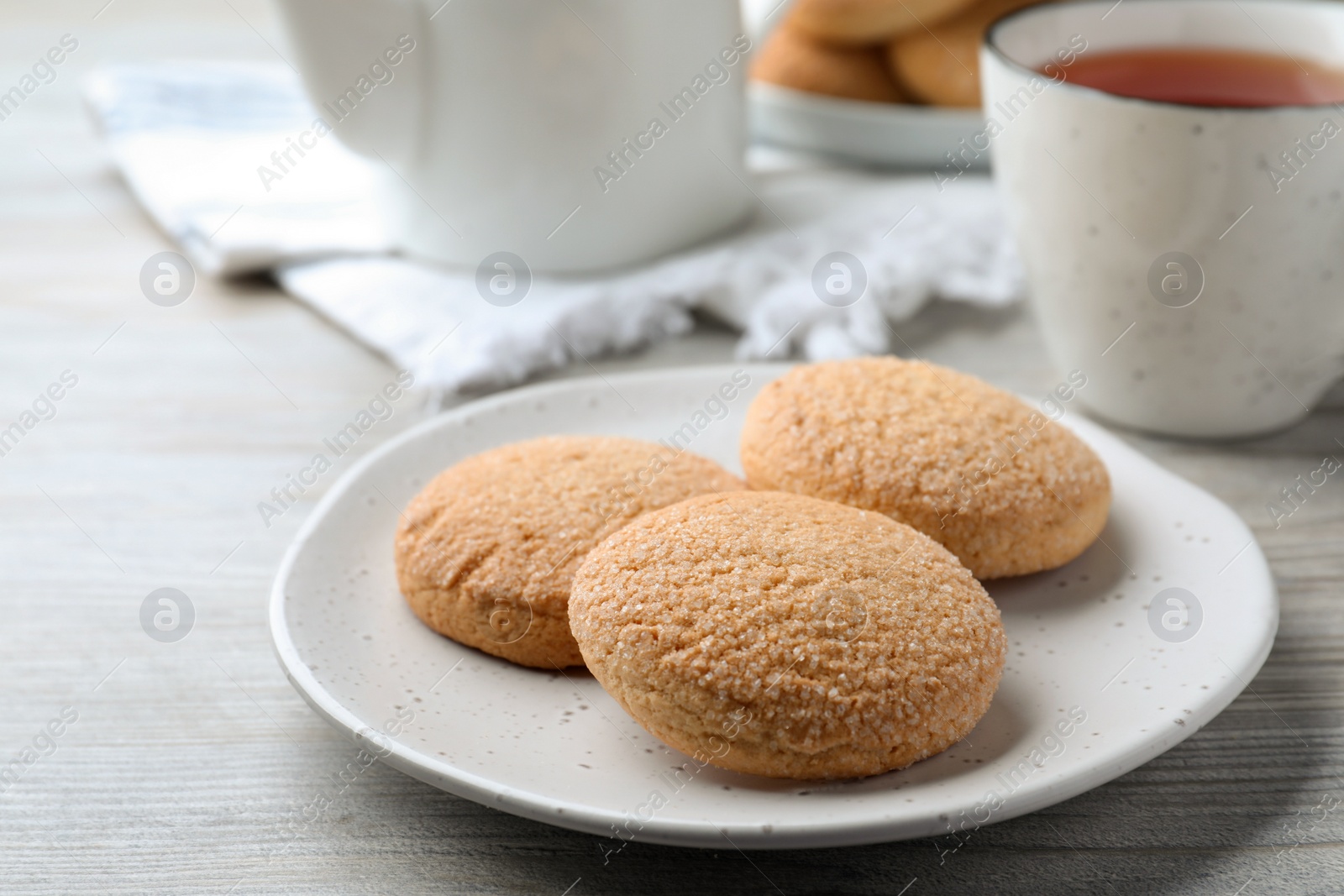 Photo of Delicious sugar cookies on white wooden table, closeup