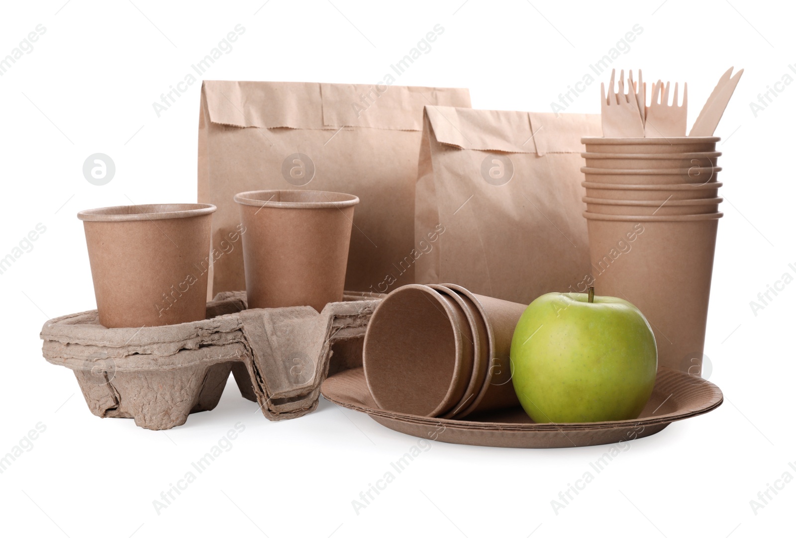 Photo of Set of disposable eco friendly dishware and apple on white background