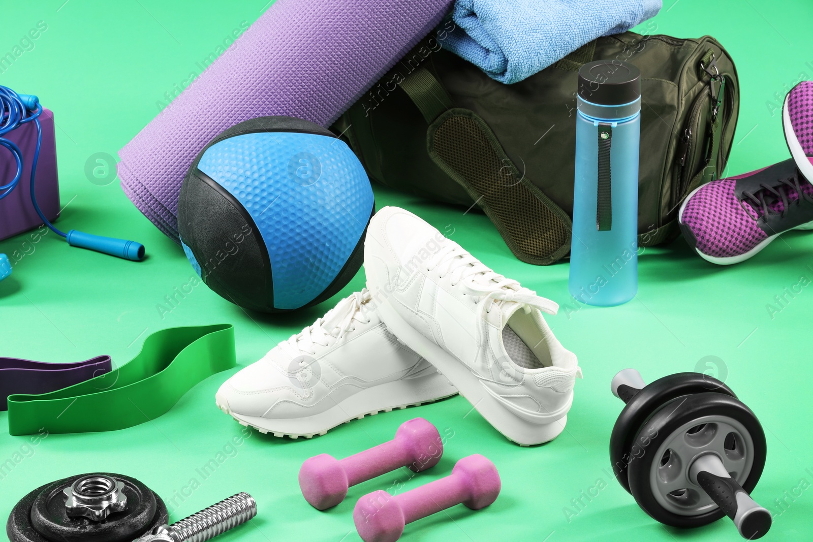 Photo of Many different sports equipment on green background