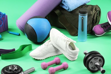 Many different sports equipment on green background