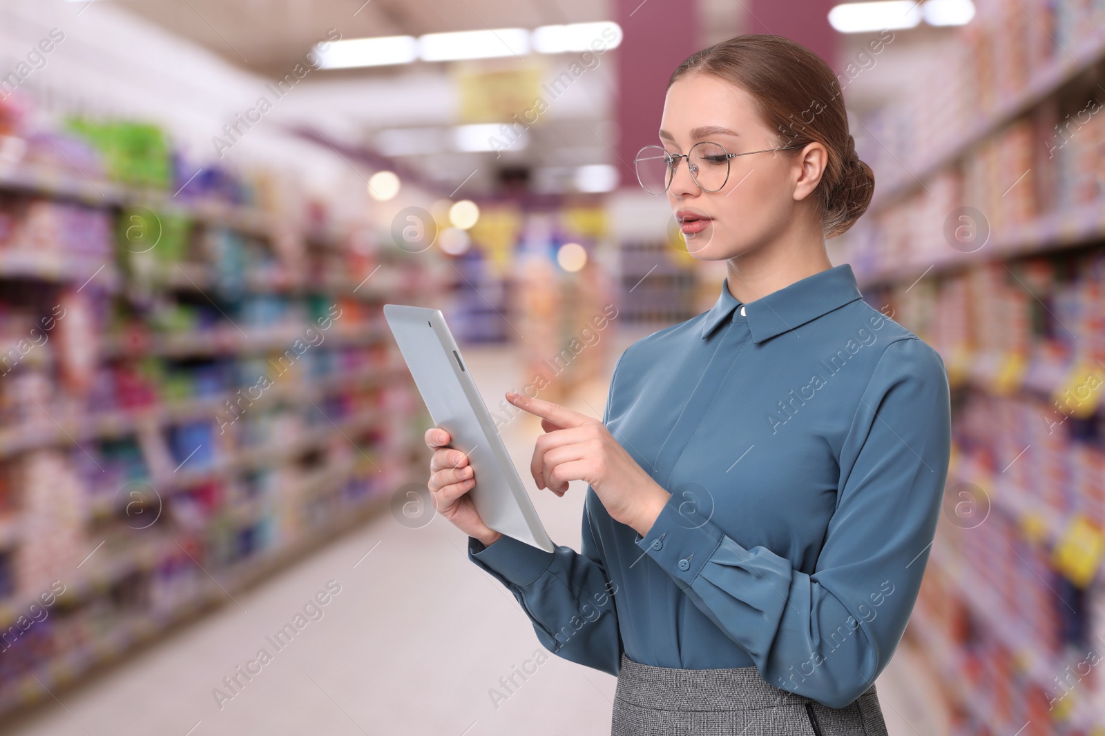 Image of Inspector with tablet in supermarket. Quality control