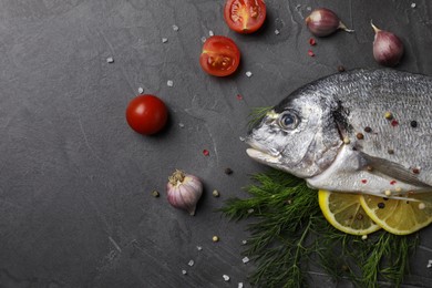 Photo of Fresh dorado fish and ingredients on grey table, flat lay. Space for text