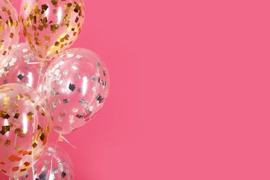Photo of Balloons with sparkles on color background, closeup. Space for text