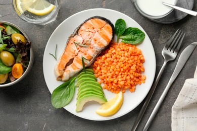 Healthy food high in vegetable fats served on grey textured table, flat lay