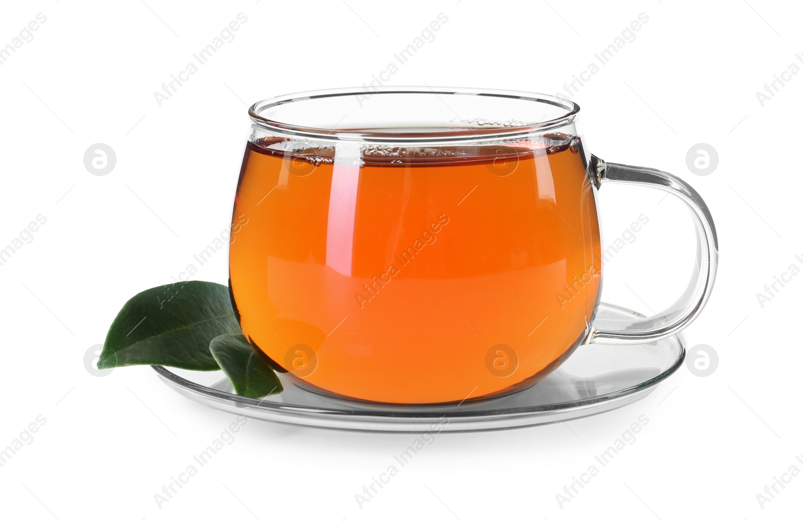 Photo of Aromatic tea in glass cup and green leaves isolated on white