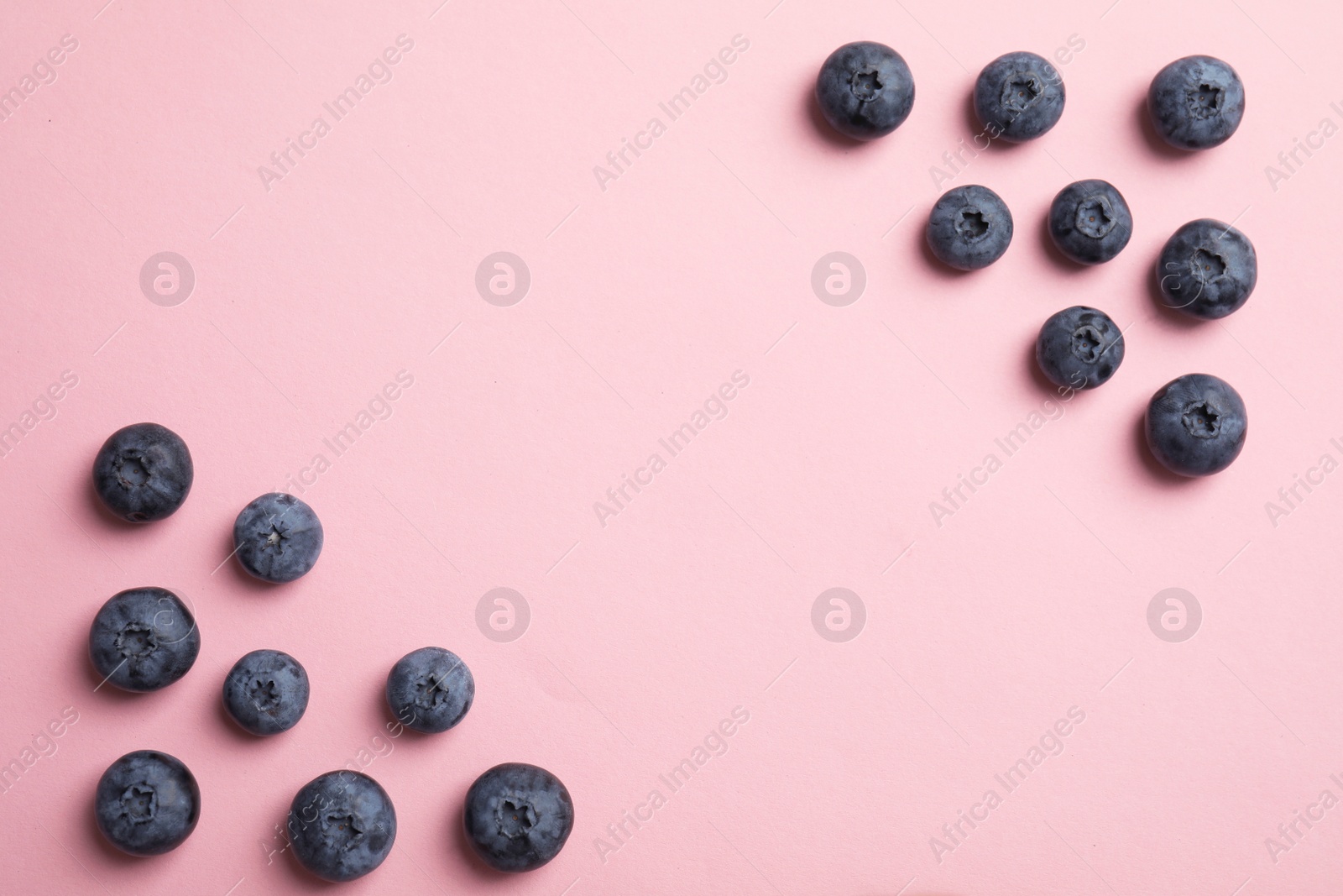 Photo of Flat lay composition with tasty blueberry and space for text on color background