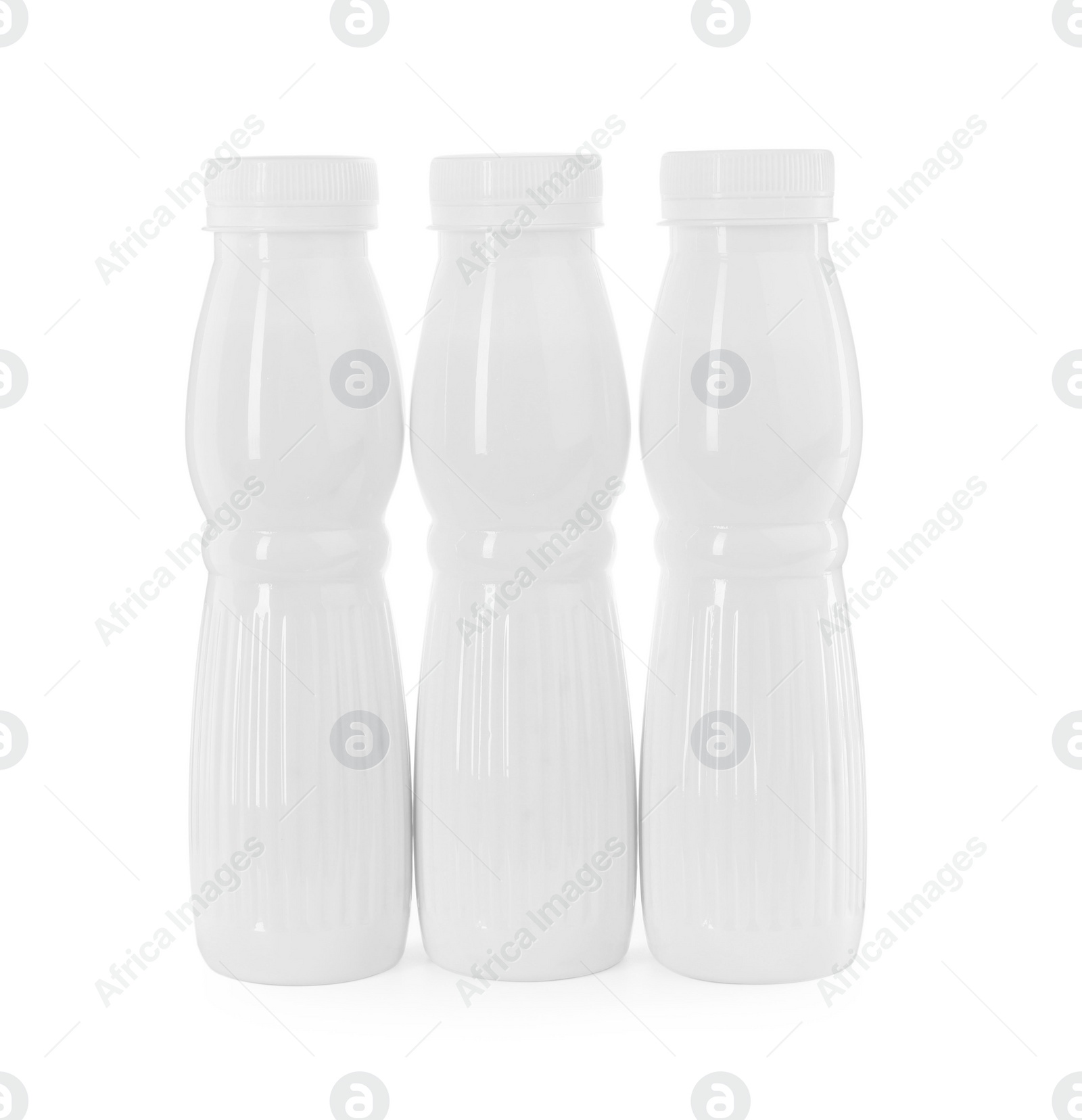 Photo of Tasty yogurt in bottles isolated on white