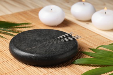 Photo of Stone coaster with acupuncture needles on table