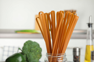 Photo of Uncooked buckwheat noodles on blurred background, closeup