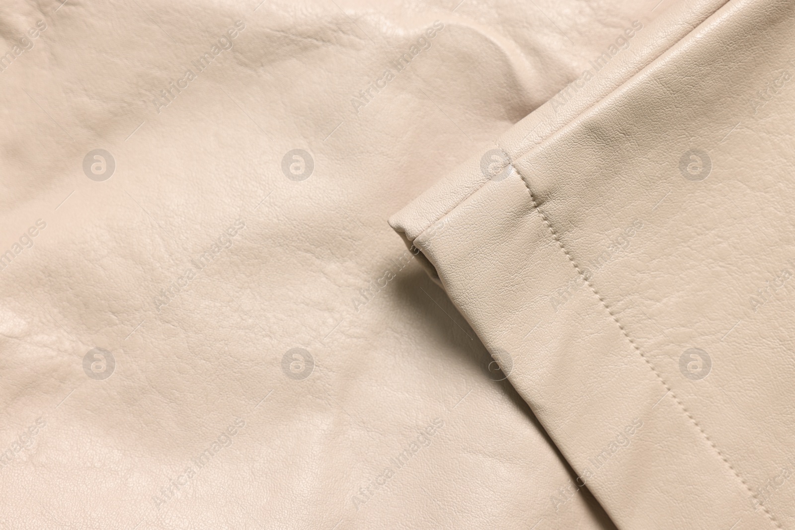 Photo of Beige natural leather with seams as background, top view