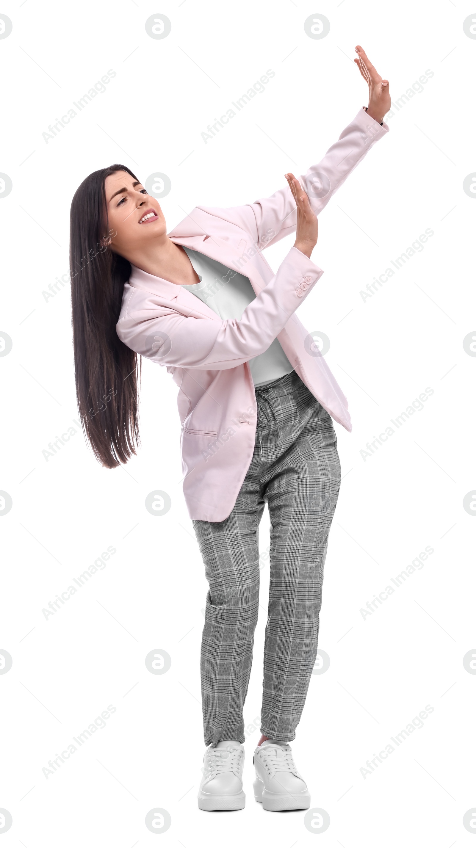 Photo of Beautiful businesswoman in suit avoiding something on white background