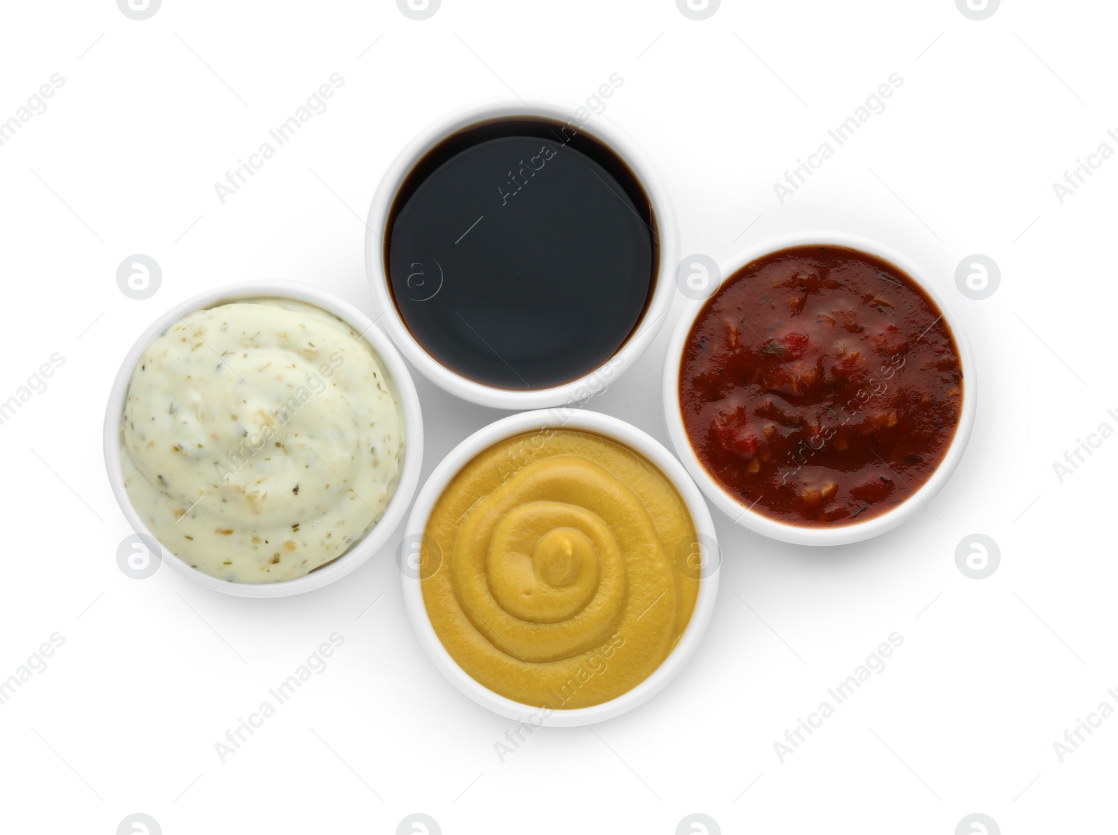 Photo of Many different sauces in bowls on white background, top view