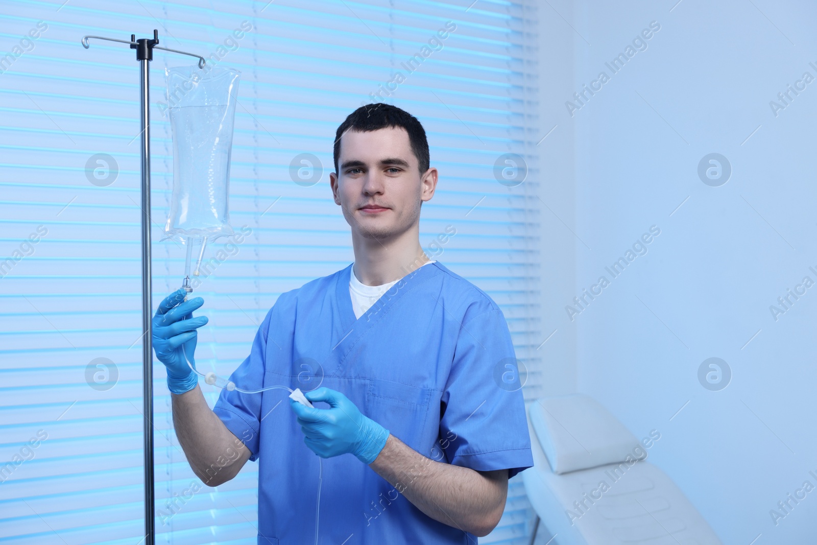 Photo of Nurse setting up IV drip in hospital