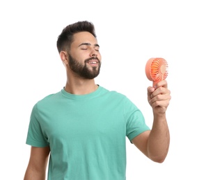 Photo of Man enjoying air flow from portable fan on white background. Summer heat