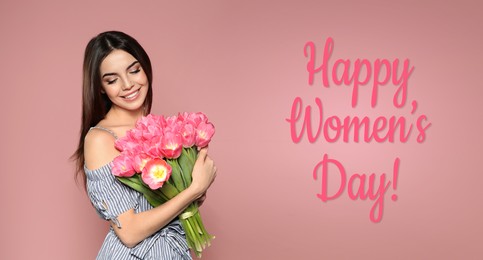 Image of Happy Women's Day, Charming lady holding bouquet of beautiful flowers on dusty pink background