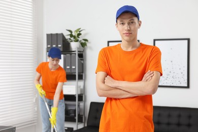 Portrait of cleaning service worker in office, selective focus