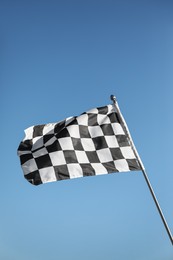 Photo of Checkered finish flag on light blue background