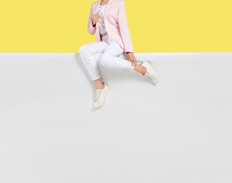 Photo of Woman wearing stylish shoes on color background, closeup