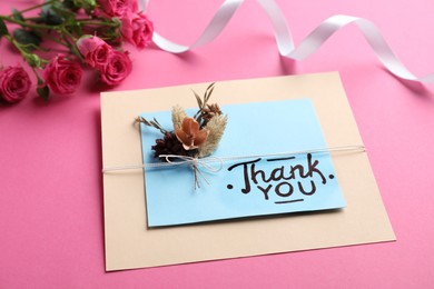 Photo of Card with phrase Thank You and beautiful flowers on pink background