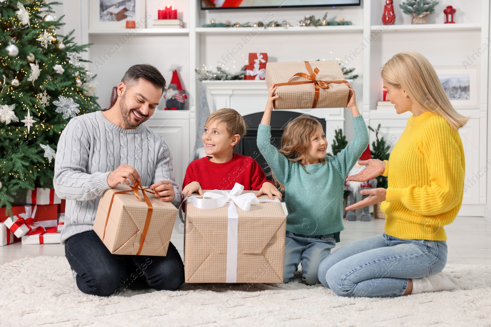 Photo of Happy family with Christmas gifts at home