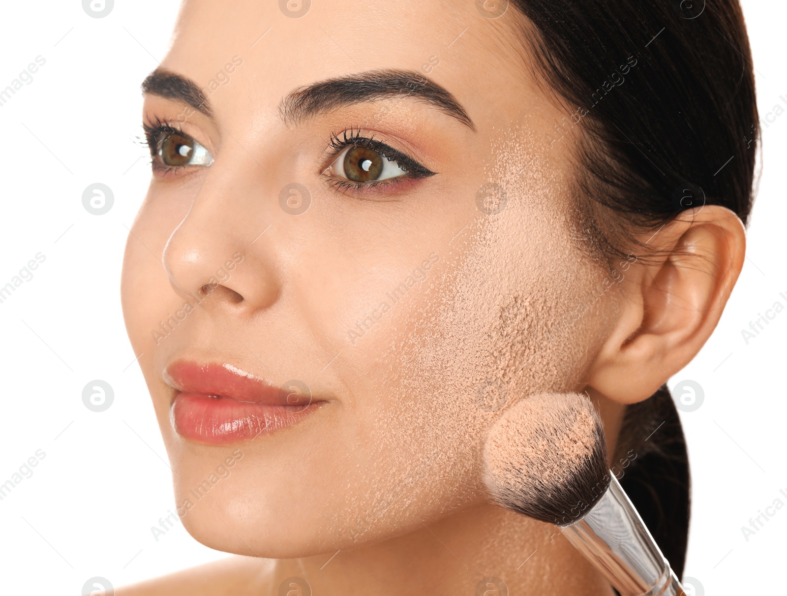 Photo of Beautiful young woman applying face powder with brush on white background, closeup