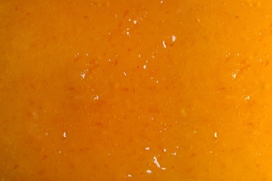 Sweet apricot jam as background, closeup view