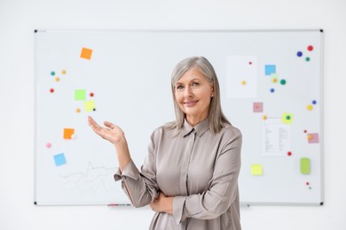 Photo of Portrait of happy professor near whiteboard indoors