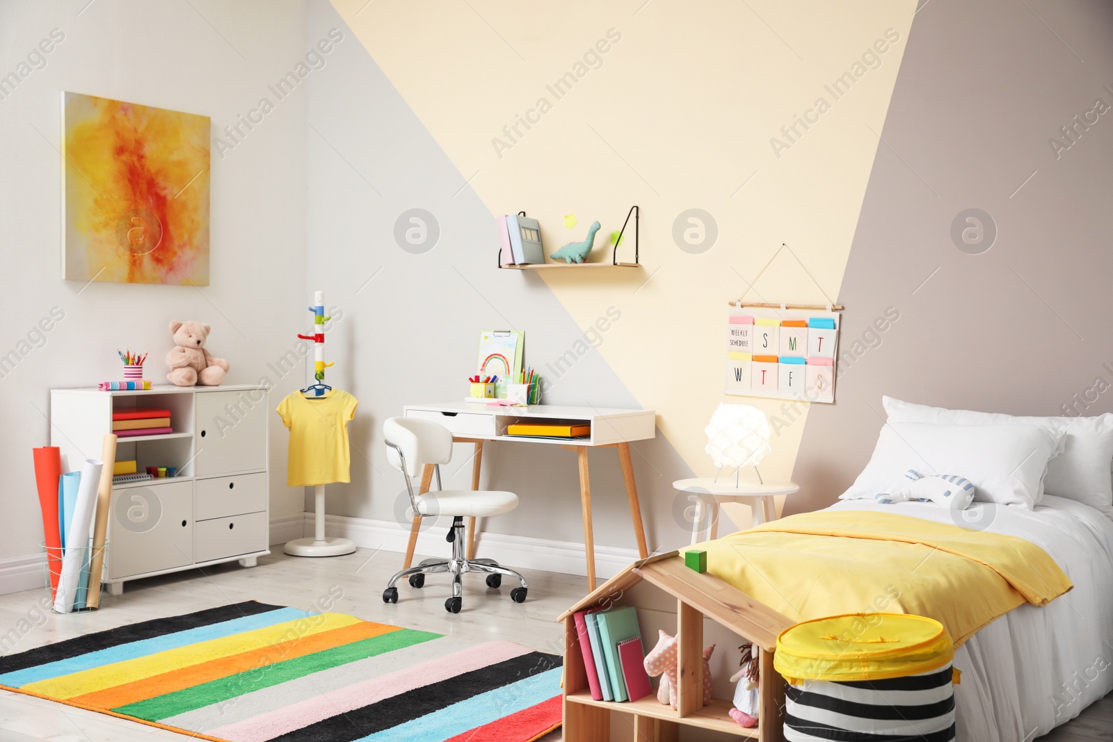 Photo of Stylish child room interior with comfortable bed and desk