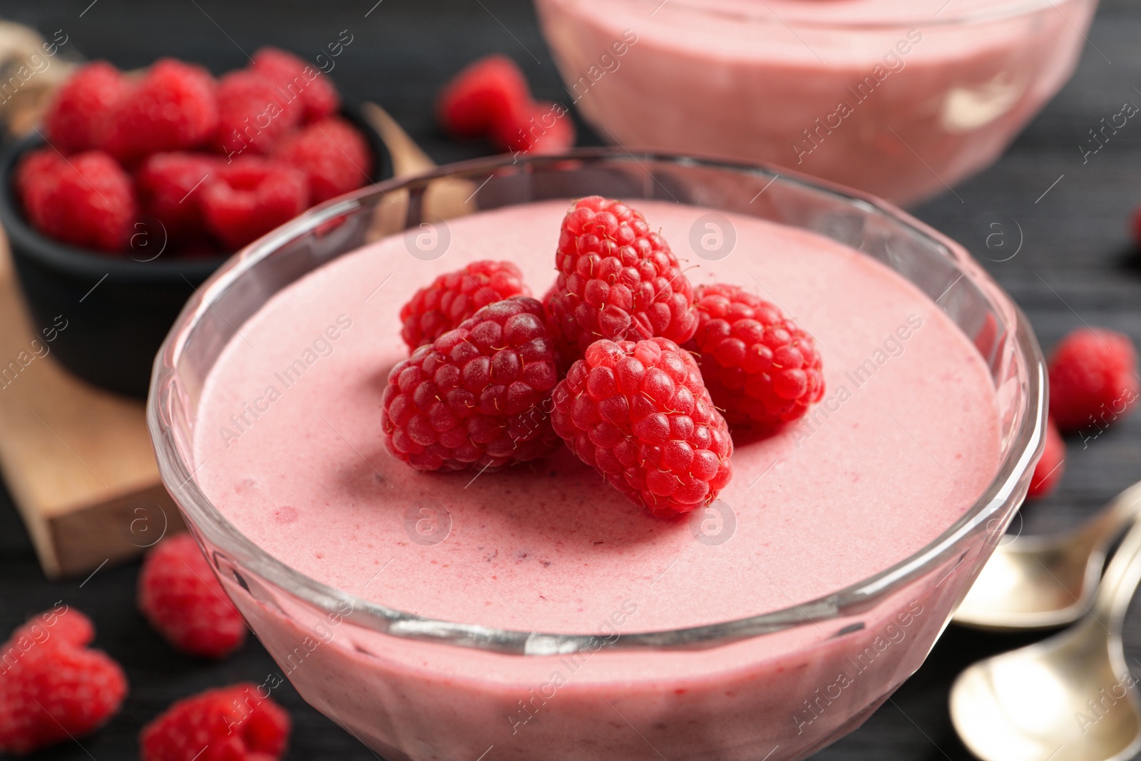 Photo of Glass of delicious raspberry mousse, closeup view