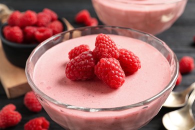 Photo of Glass of delicious raspberry mousse, closeup view