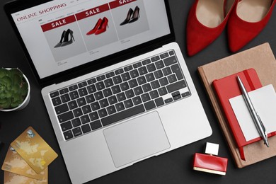 Online shopping. Composition with laptop on black background, above view