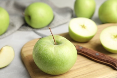 Composition with fresh ripe green apples on grey table, space for text