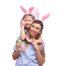 Photo of Easter celebration. Mother and her cute daughter with bunny ears and painted eggs isolated on white