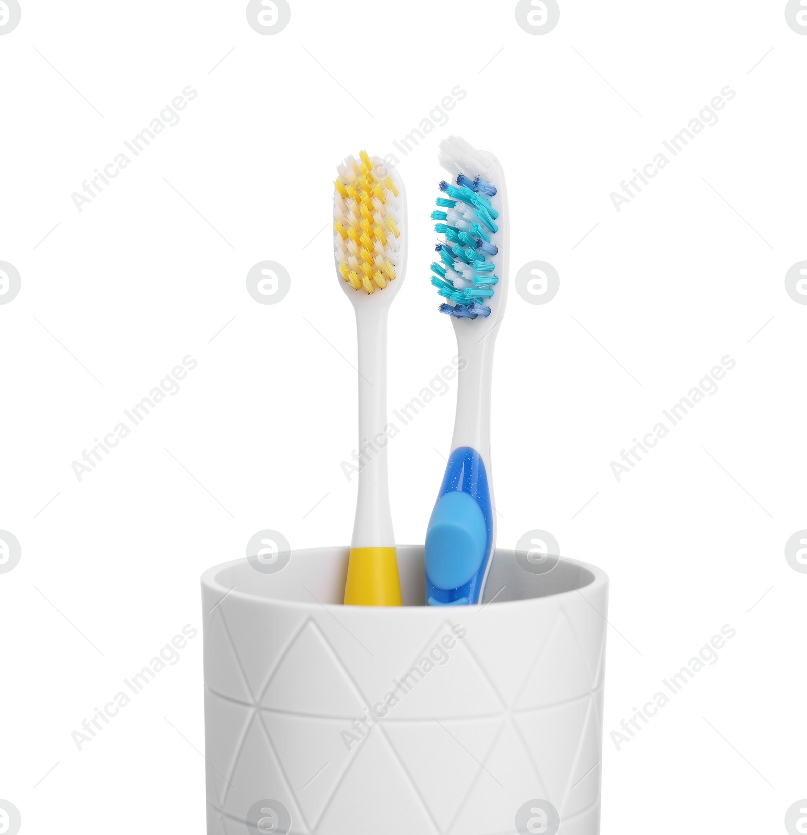 Photo of Two plastic toothbrushes in holder isolated on white