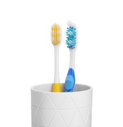 Photo of Two plastic toothbrushes in holder isolated on white