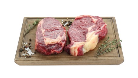 Photo of Pieces of fresh beef meat, thyme and spices on white background